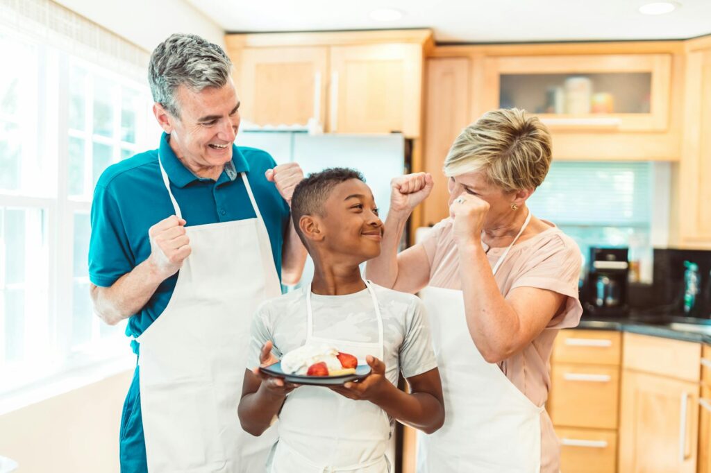 Family enjoying cooking together at home, celebrating their creation with joy and smiles.