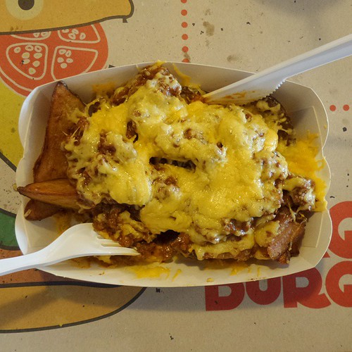 Mr Coney Island saucy steak potatoes with cheddar and extra bacon isn't smiling to me. 😑 maybe he misses the burger.