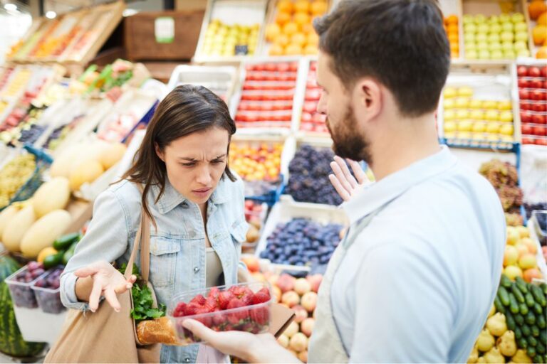 woman looking at strawberries annoyed