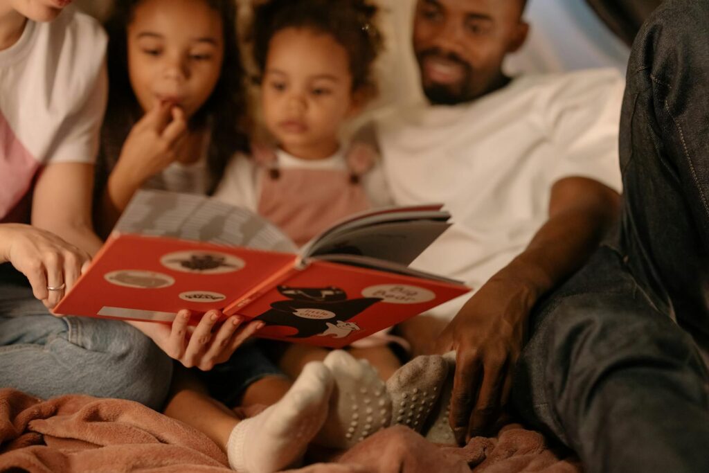 A family enjoys a cozy reading session together, sharing quality time indoors.