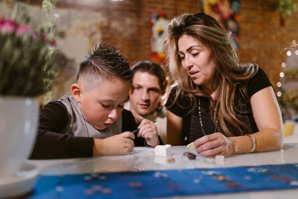 A family enjoying quality time creating art and crafts together indoors.