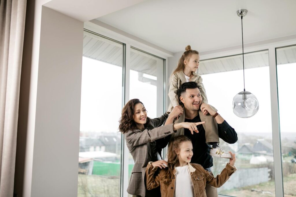 A joyful family of four spending quality time inside their new house, creating cherished memories.