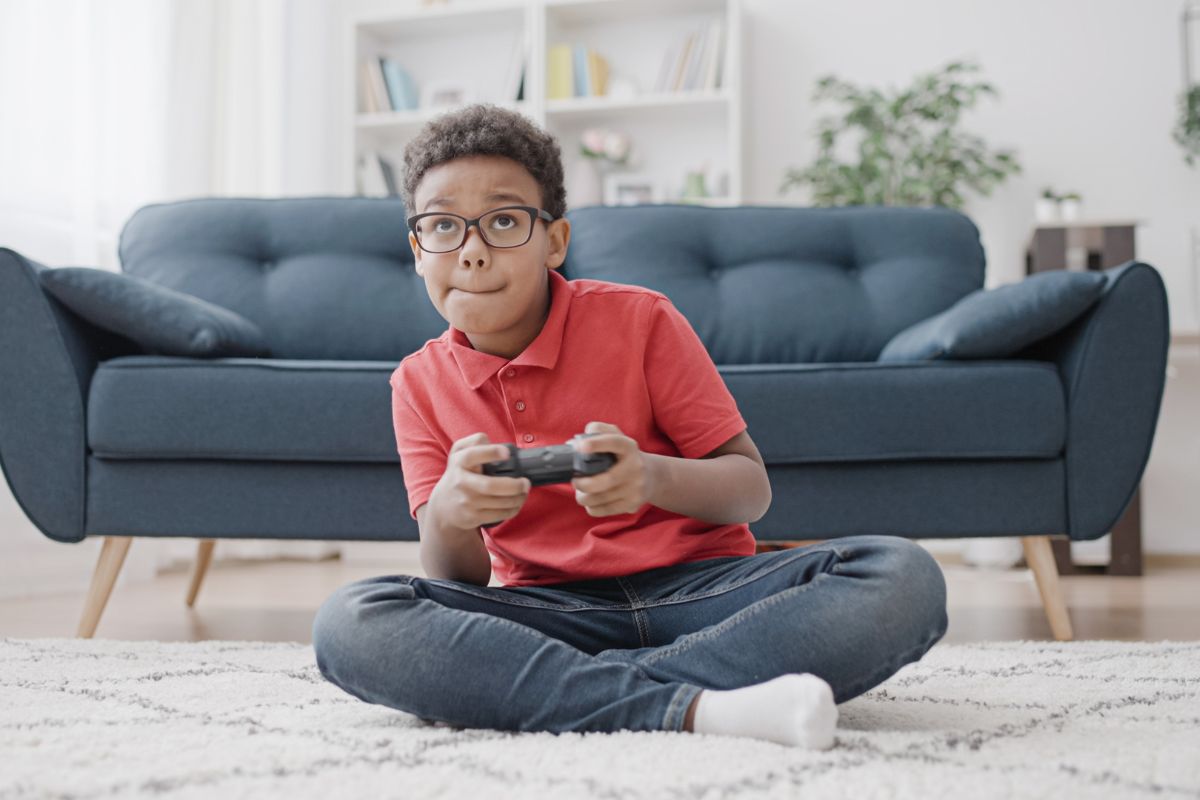 Boy playing video games in the living room