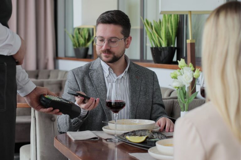 Couple on a date, man paying the bill