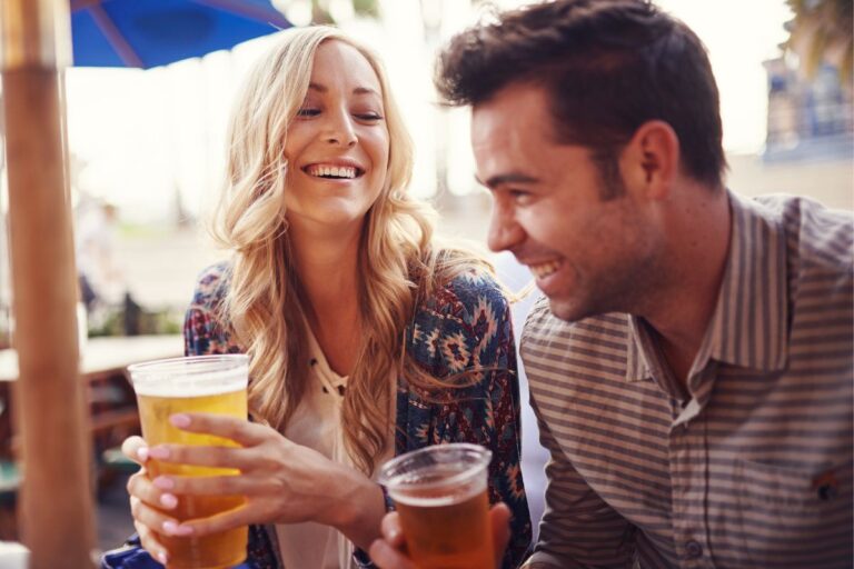couple drinking beer at a patio on a date