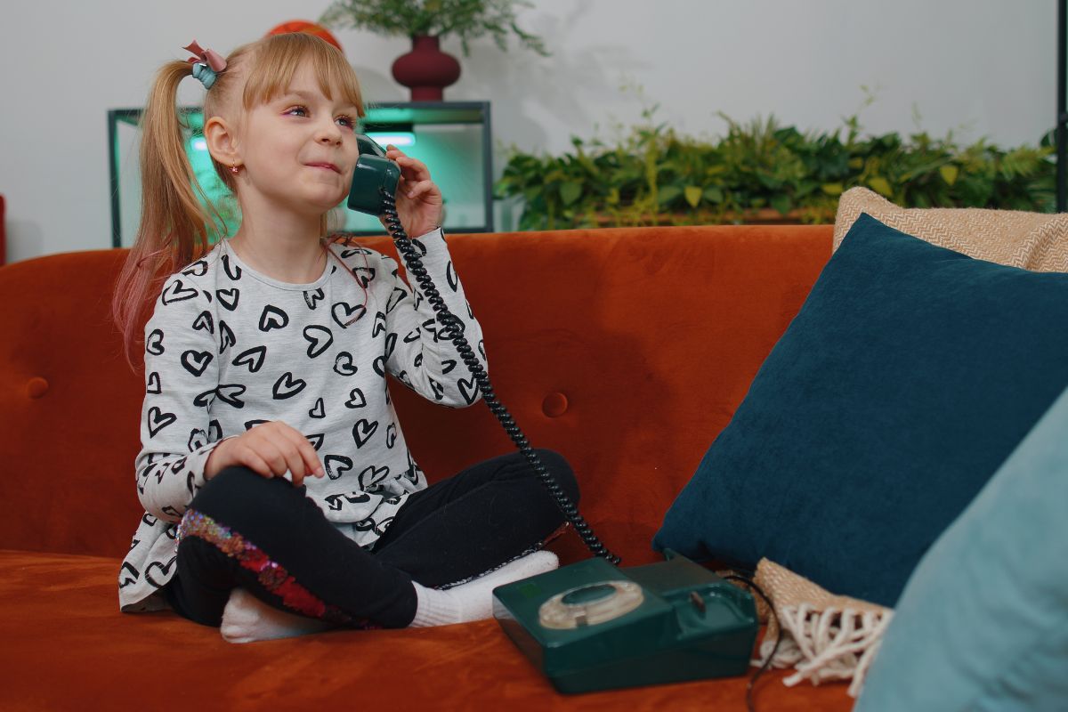 girl on a home phone on the couch