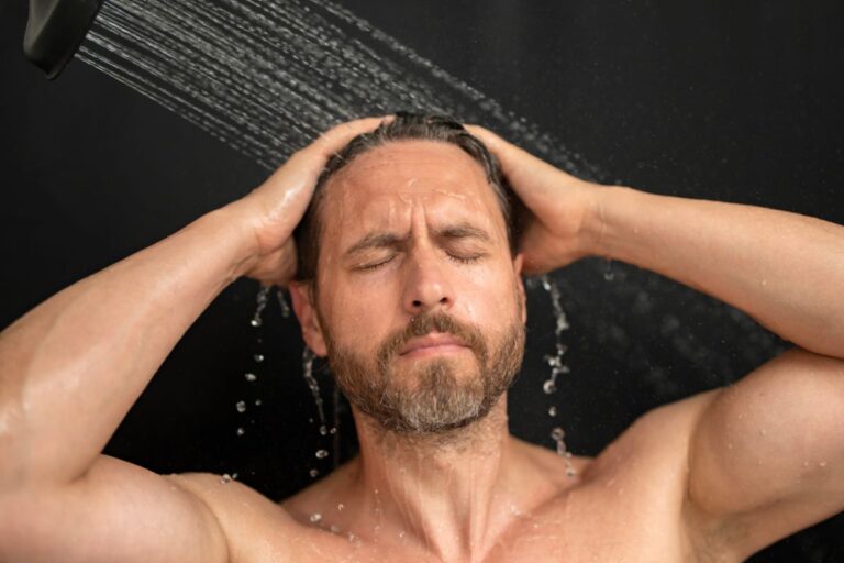 man washing his hair in the shower