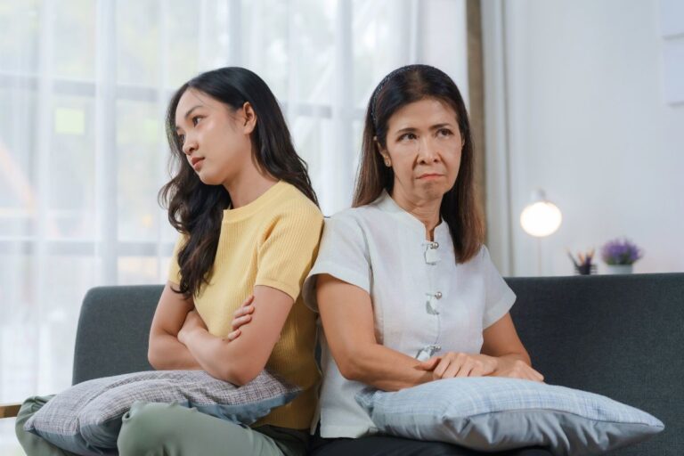 teen and her mom sitting looking annoyed at eachother
