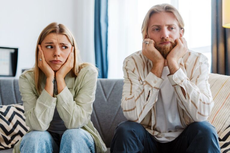 woman and man looking bored on the couch
