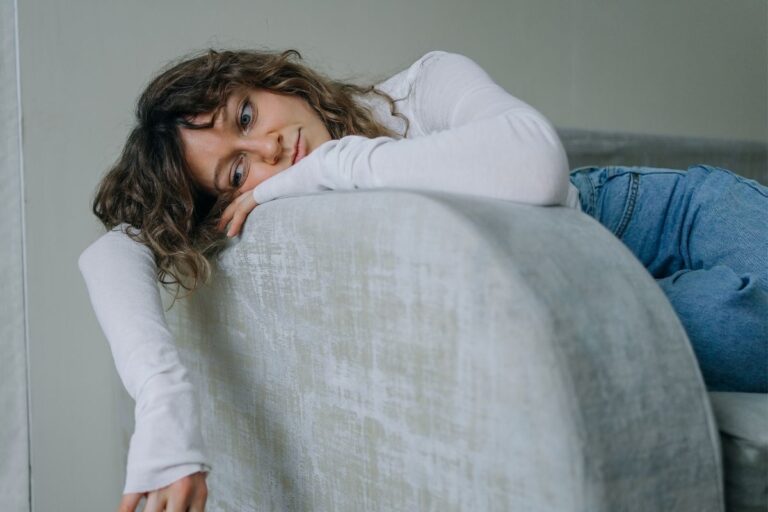 woman bored hanging over the couch