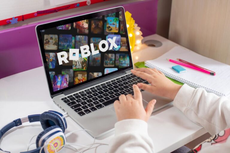 child on a laptop with roblox on the screen