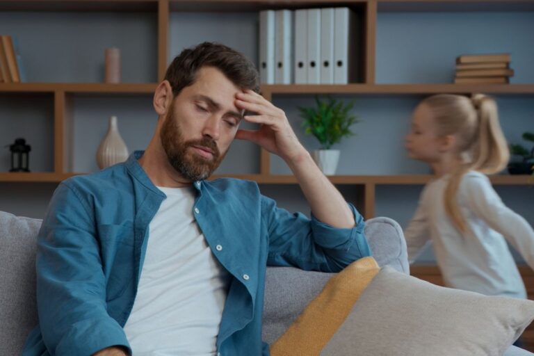 dad looking stressed and daughter behind him