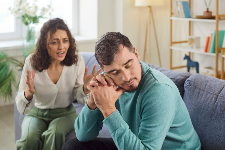 wife yelling at husband on the couch