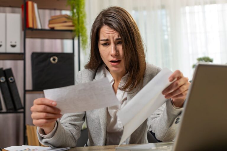 woman looking at paperwork shocked