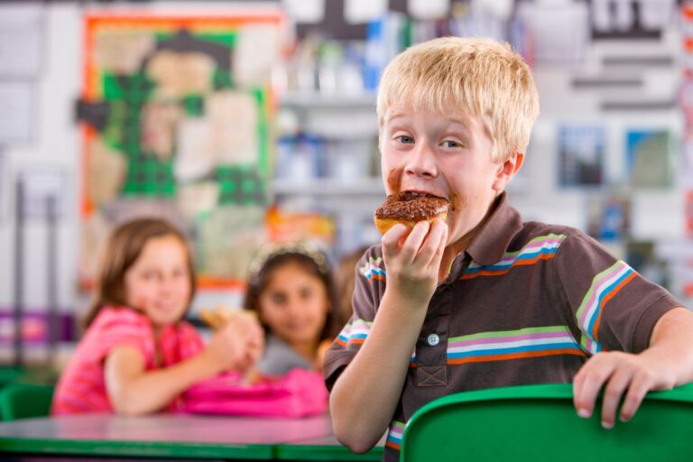 Boy eating dessert at school at lunch
