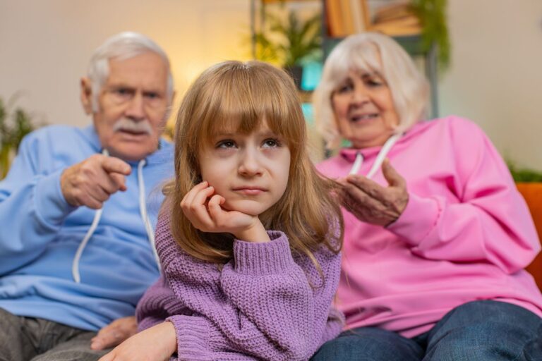 Grandparents pointing to granddaughter