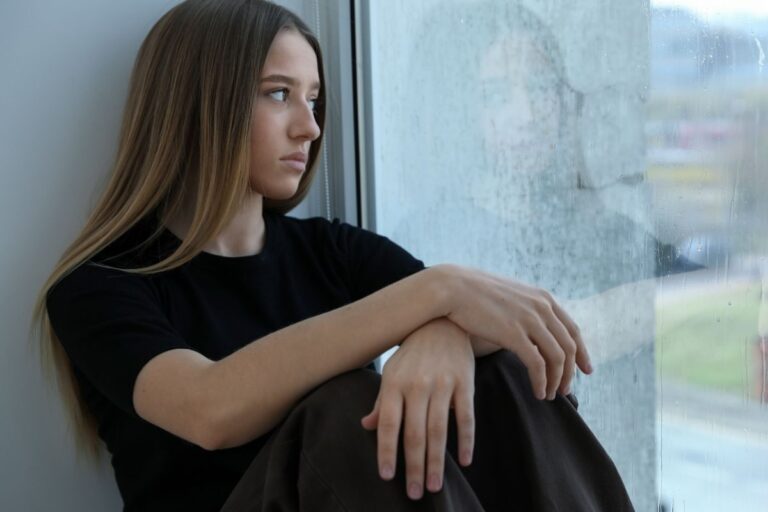 Teen looking out the window