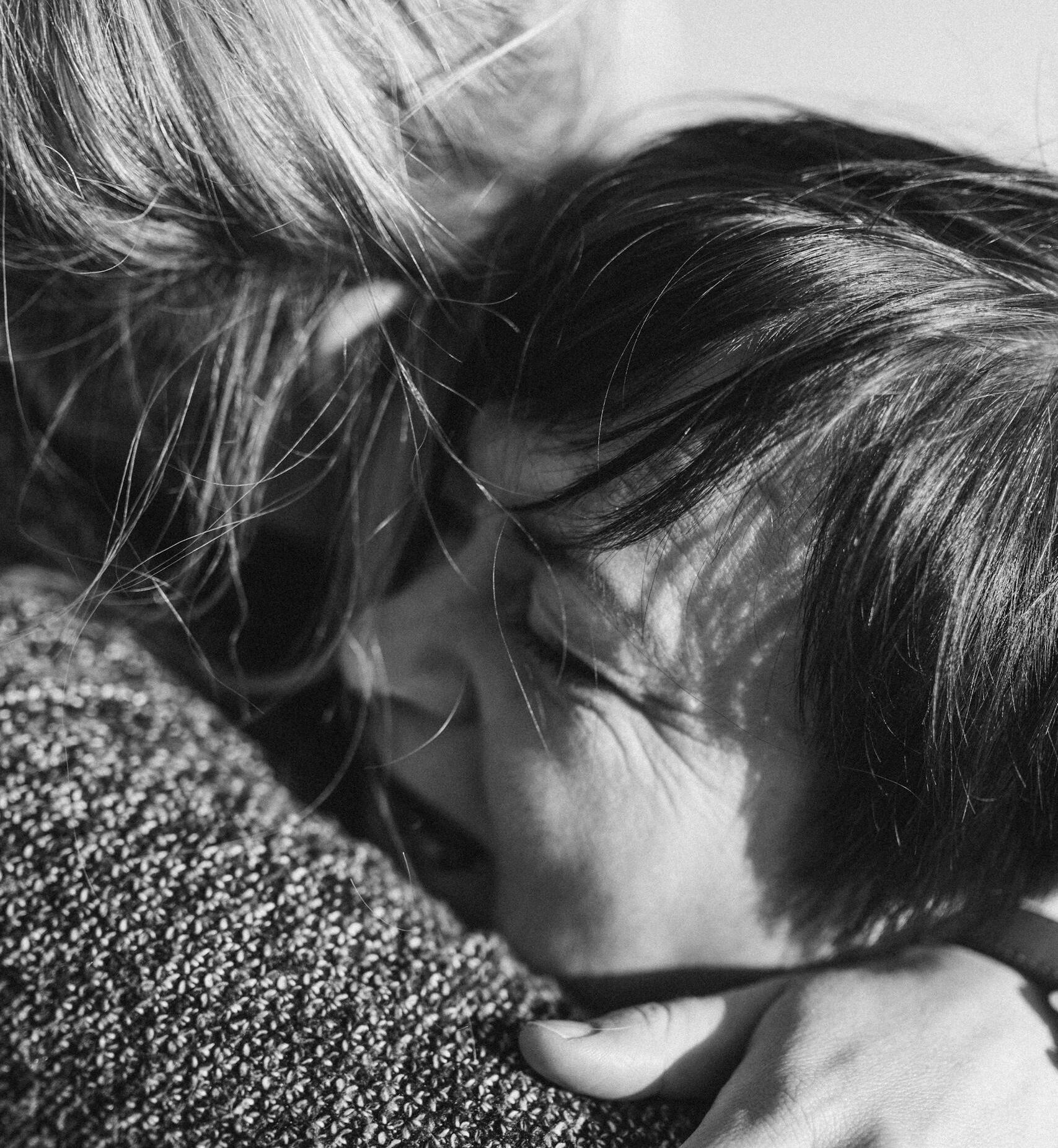 Heartfelt black and white portrait capturing a loving embrace between mother and child.