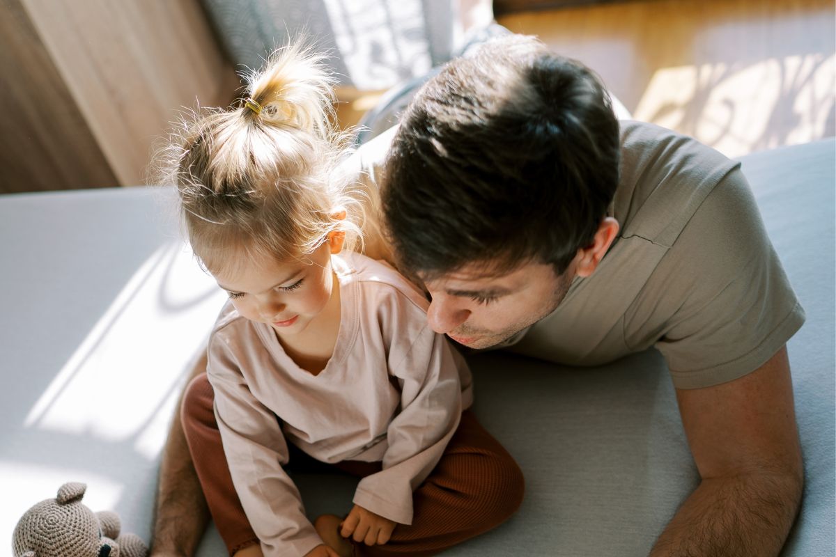 dad and toddler reading abook
