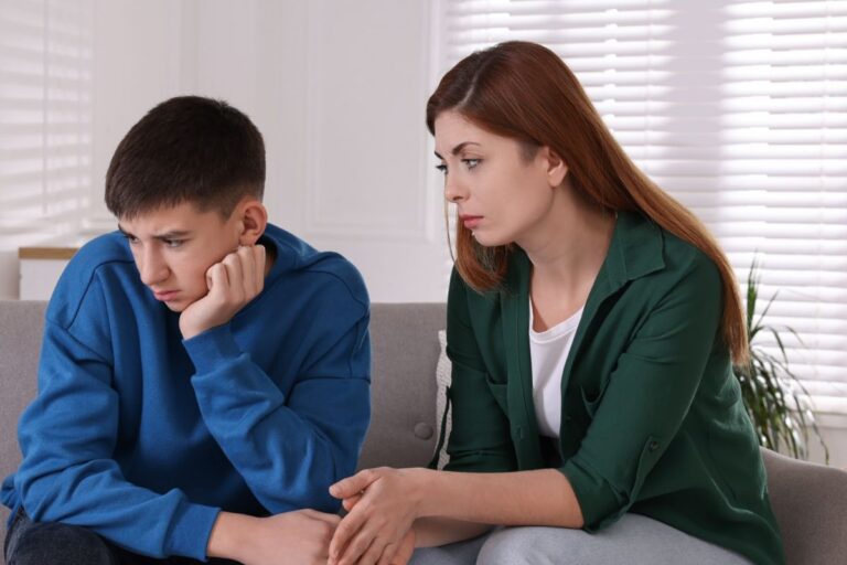 mom and teen son, son looking sad