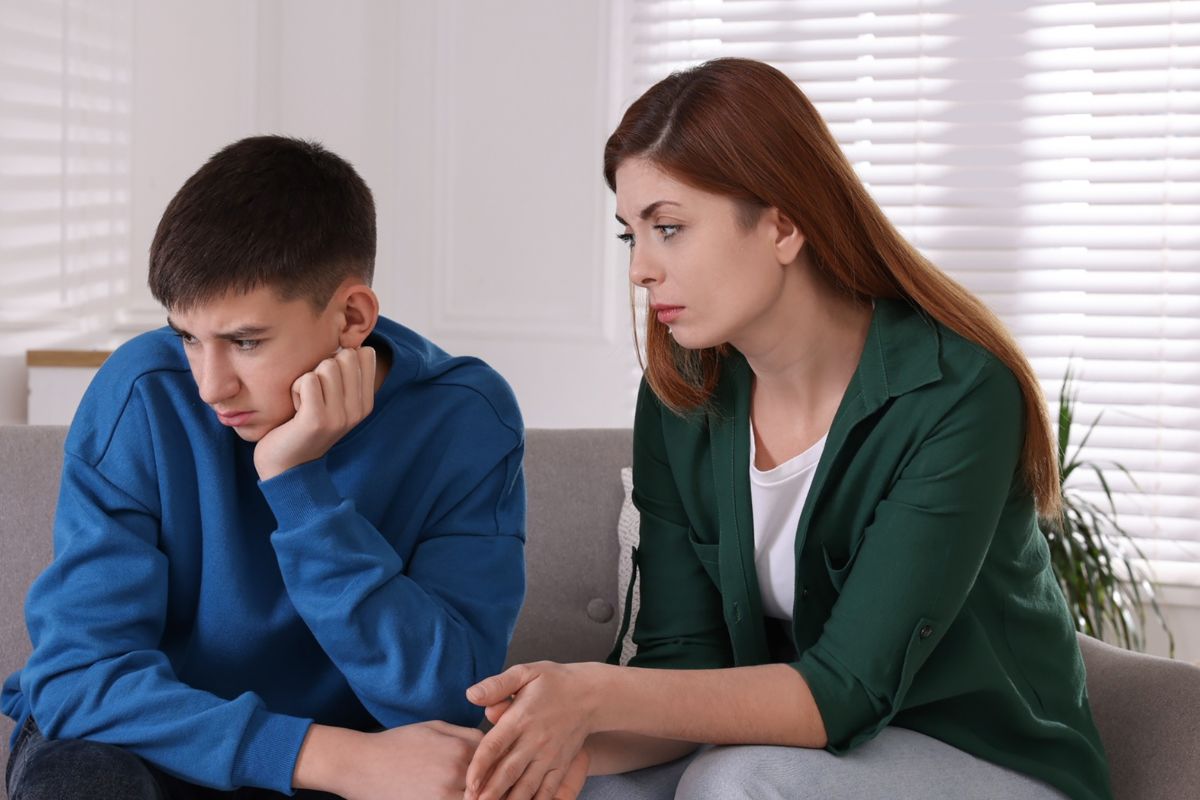 mom and teen son, son looking sad