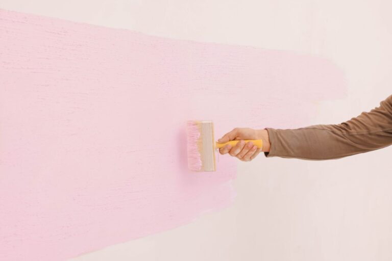 paint roller painting a pink room