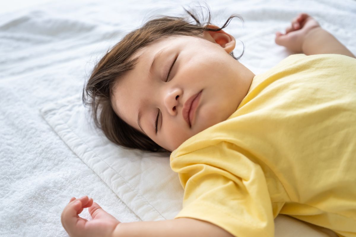 toddler sleeping on the floor