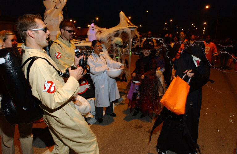 Children in Halloween costumes going trick-or-treating in a residential neighborhood