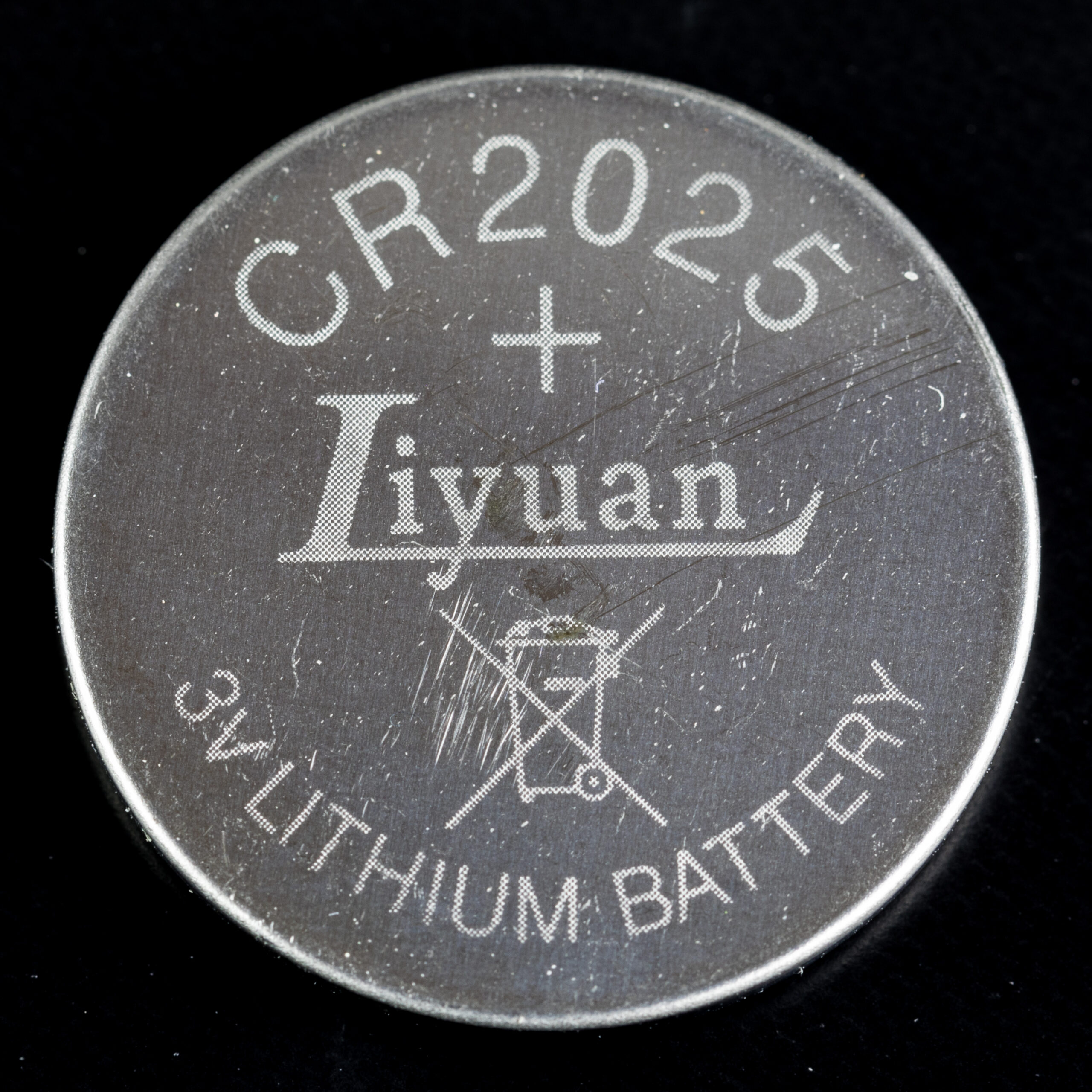 Close-up of a small round lithium coin cell battery