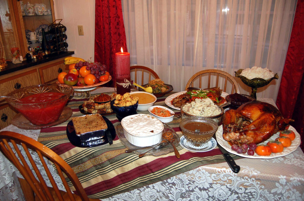 A Thanksgiving dinner with roast turkey and side dishes on a table