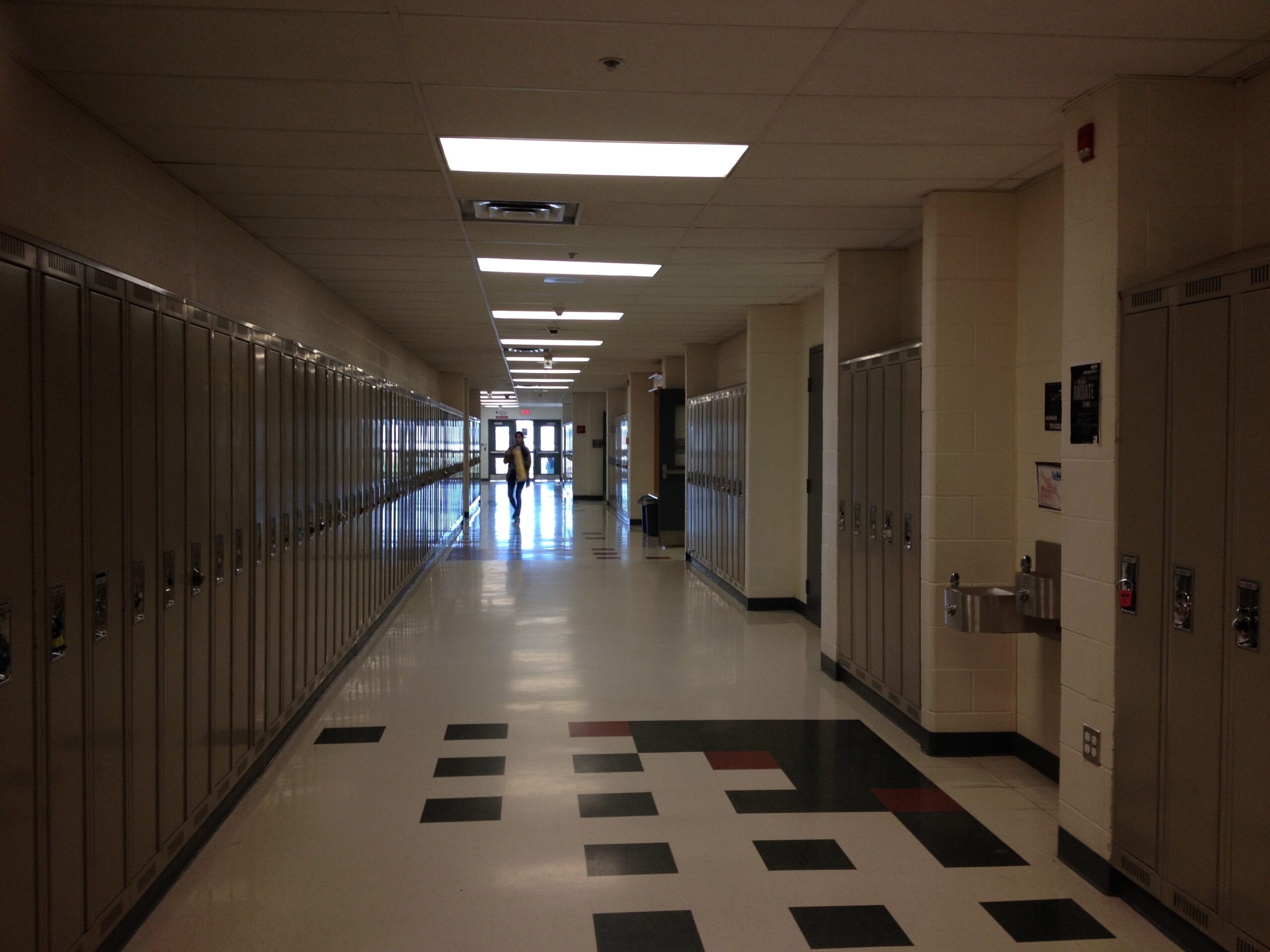 An empty school hallway lined with lockers