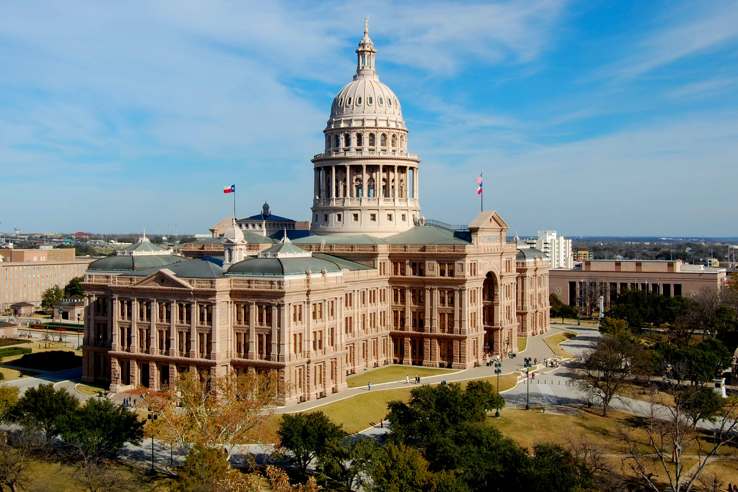 The Texas State Capitol building in Austin under a blue sky
