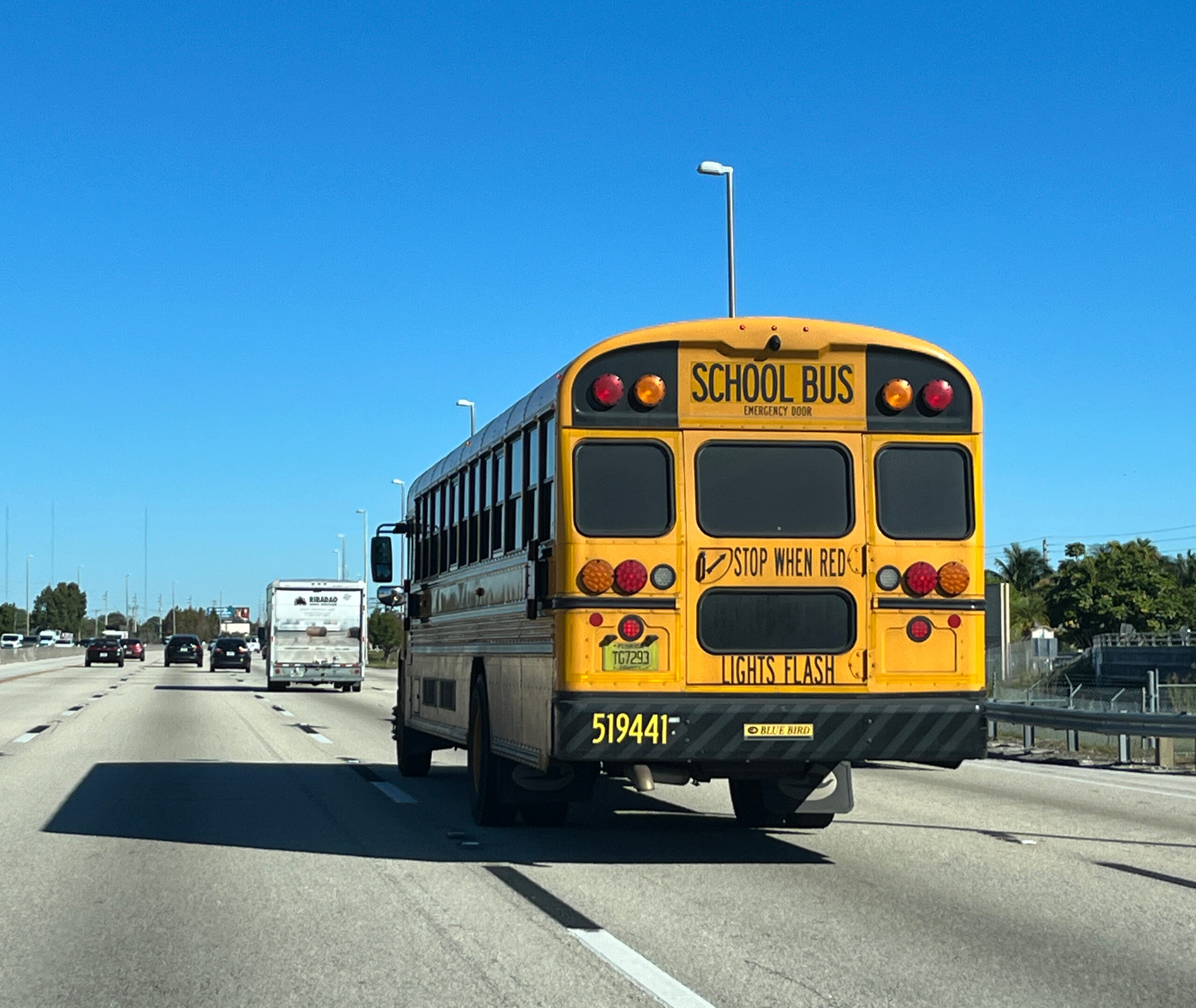 A yellow school bus traveling on Florida's Turnpike
